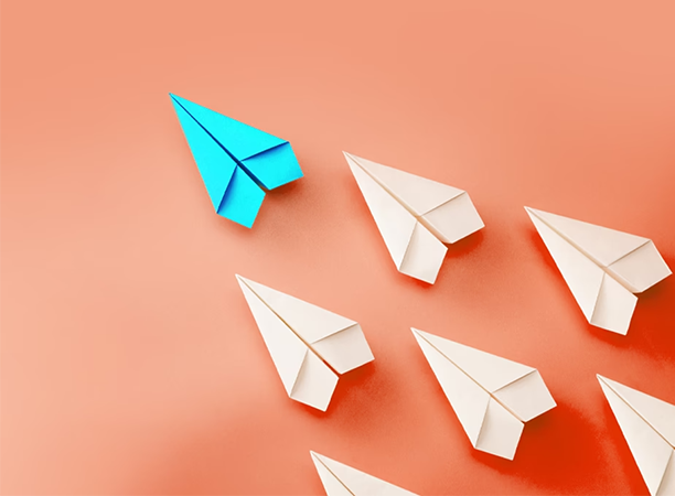 Graphic of paper airplanes on a light orange background.