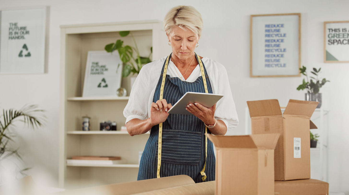 Photo of a woman using a tablet to monitor inventory.