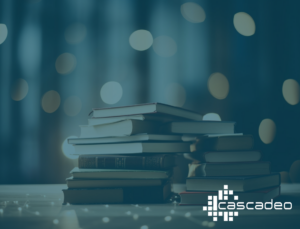 Decorative image of a stack of books surrounded by twinkling lights behind a blue overlay and the Cascadeo logo in white.